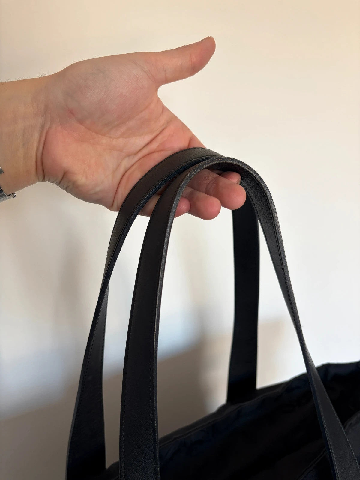 Chanel black shopping tote with woven CC jacquard pattern and smooth calfskin handles.