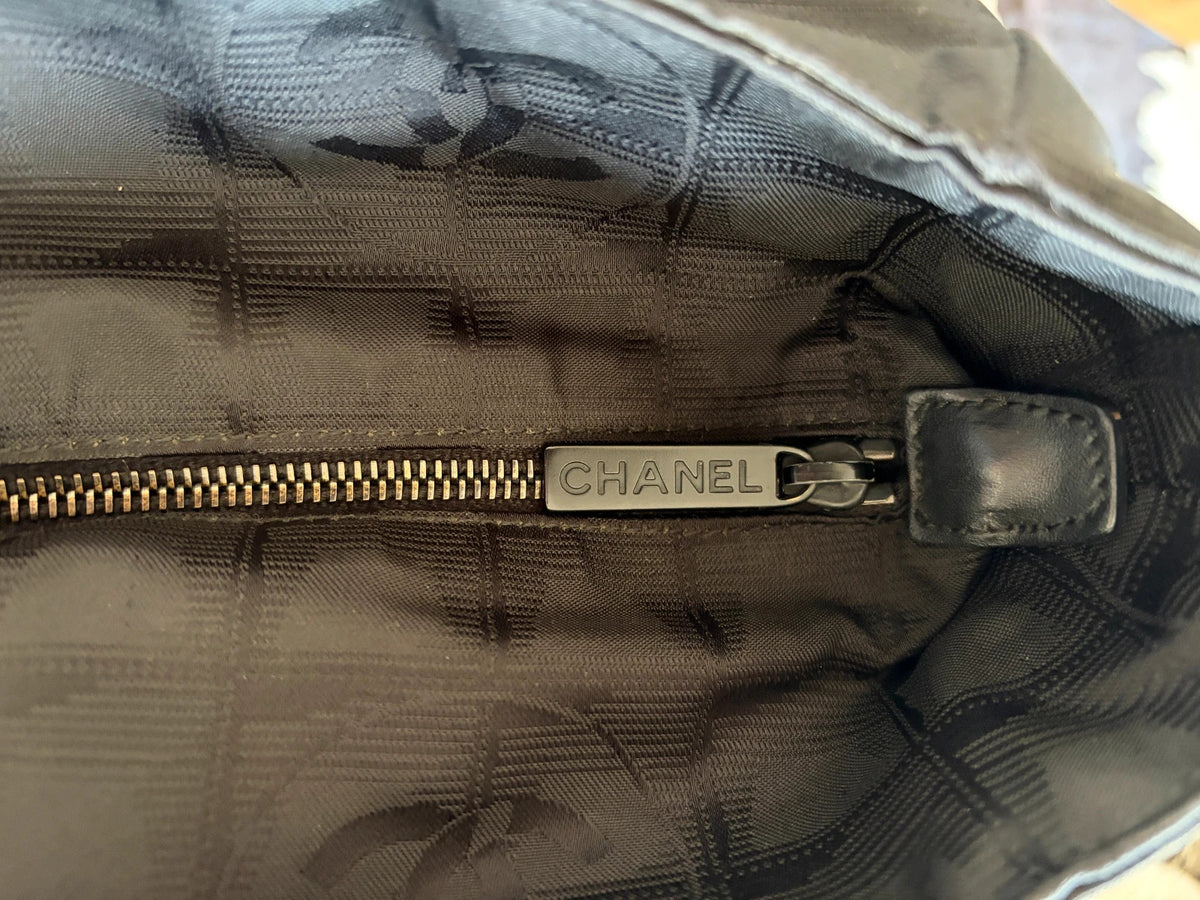 Chanel black shopping tote with woven CC jacquard pattern and smooth calfskin handles.