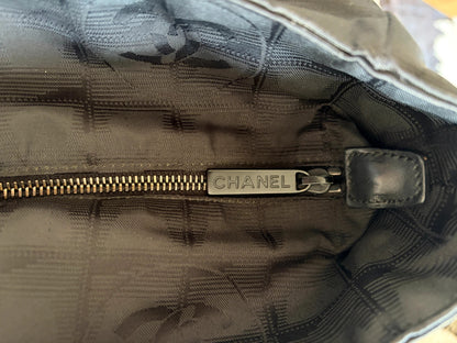 Chanel black shopping tote with woven CC jacquard pattern and smooth calfskin handles.