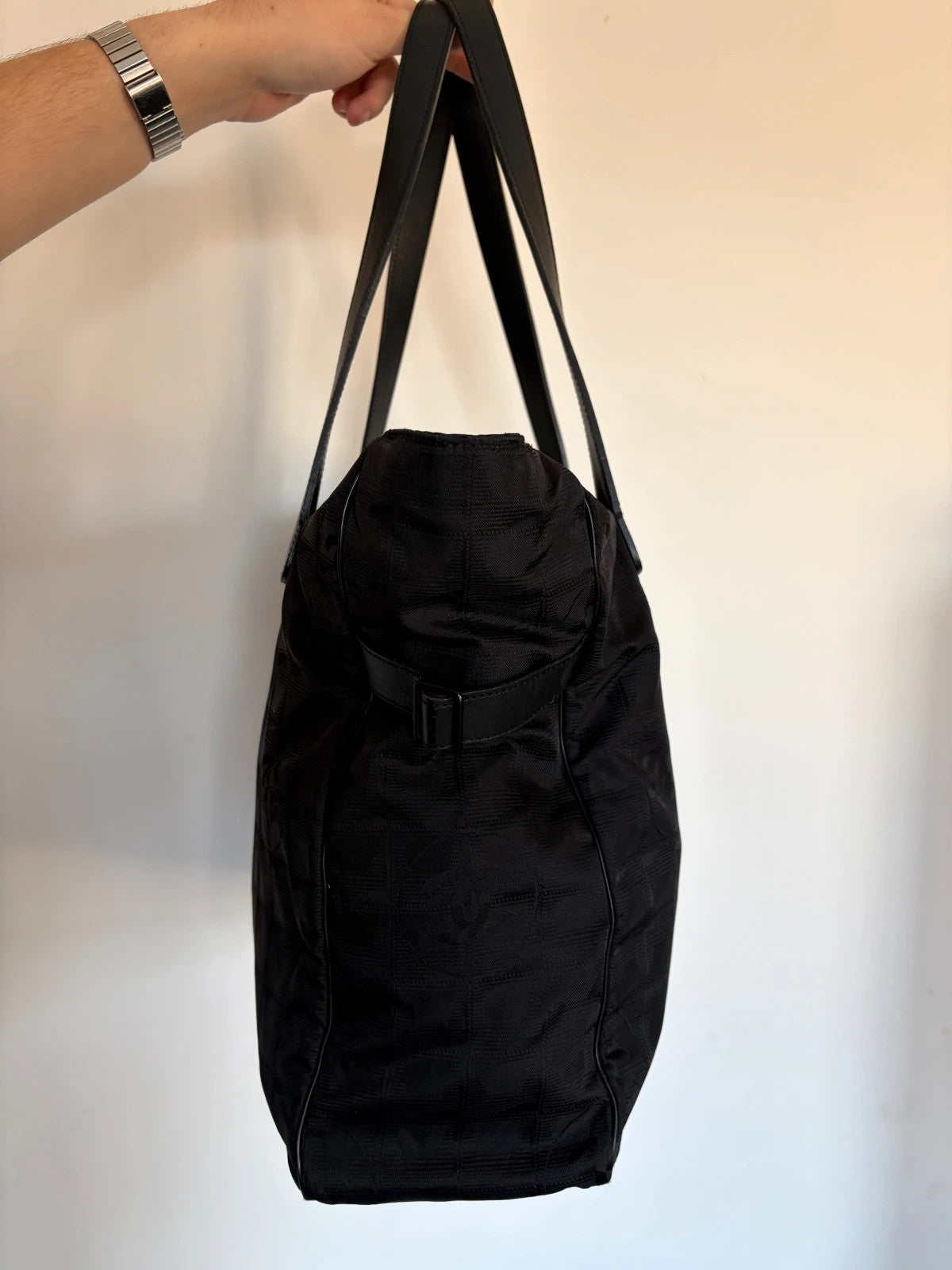 Chanel black shopping tote with woven CC jacquard pattern and smooth calfskin handles.
