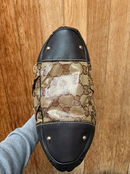Gucci beige hobo bag with GG Crystal canvas, ruched design, and gold-tone hardware.
