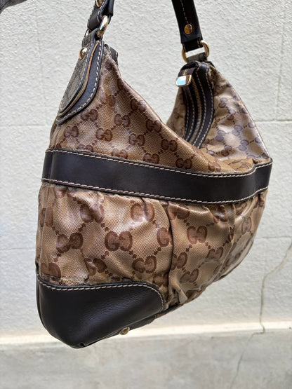 Gucci beige hobo bag with GG Crystal canvas, ruched design, and gold-tone hardware.