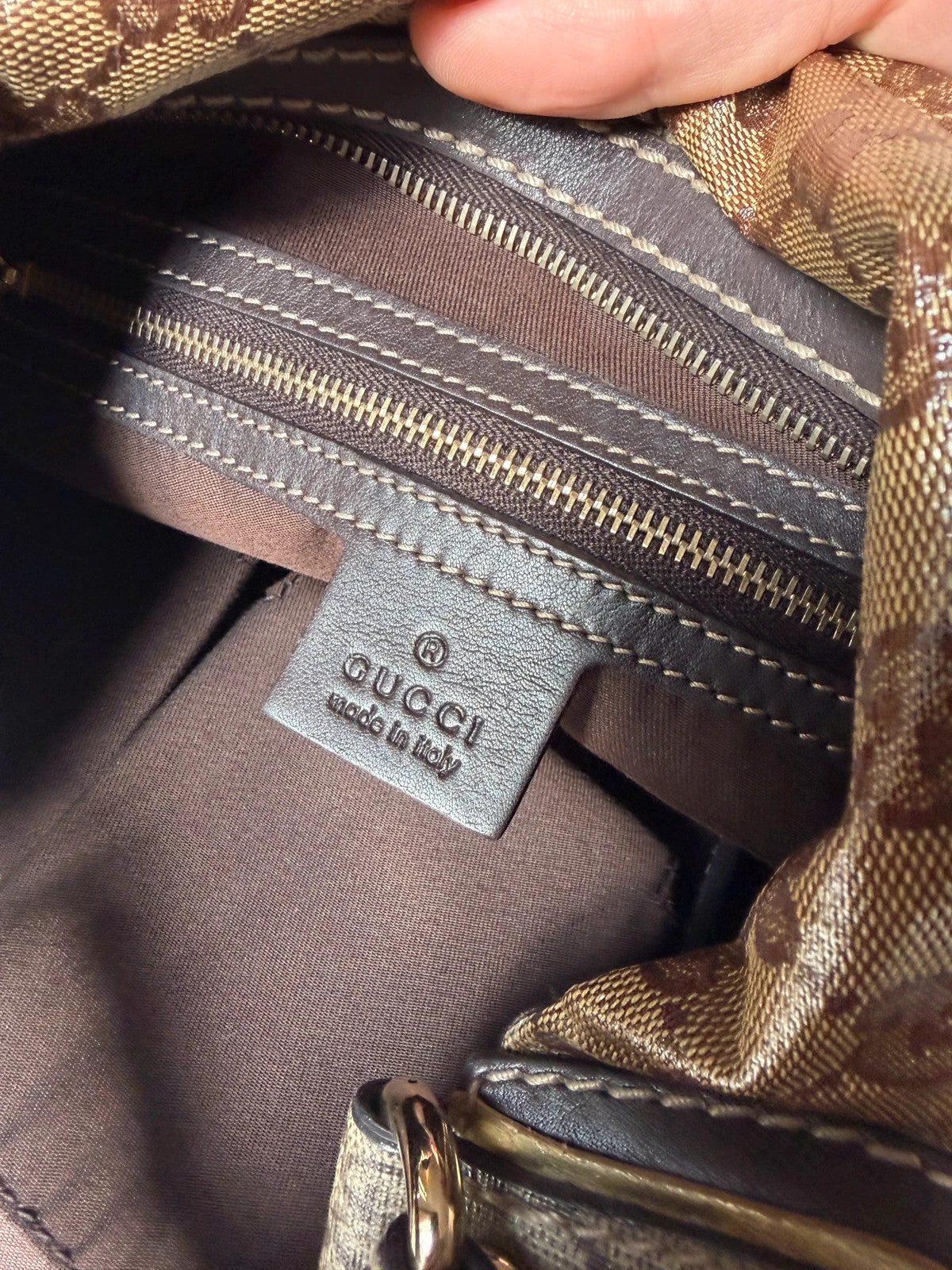 Gucci beige hobo bag with GG Crystal canvas, ruched design, and gold-tone hardware.