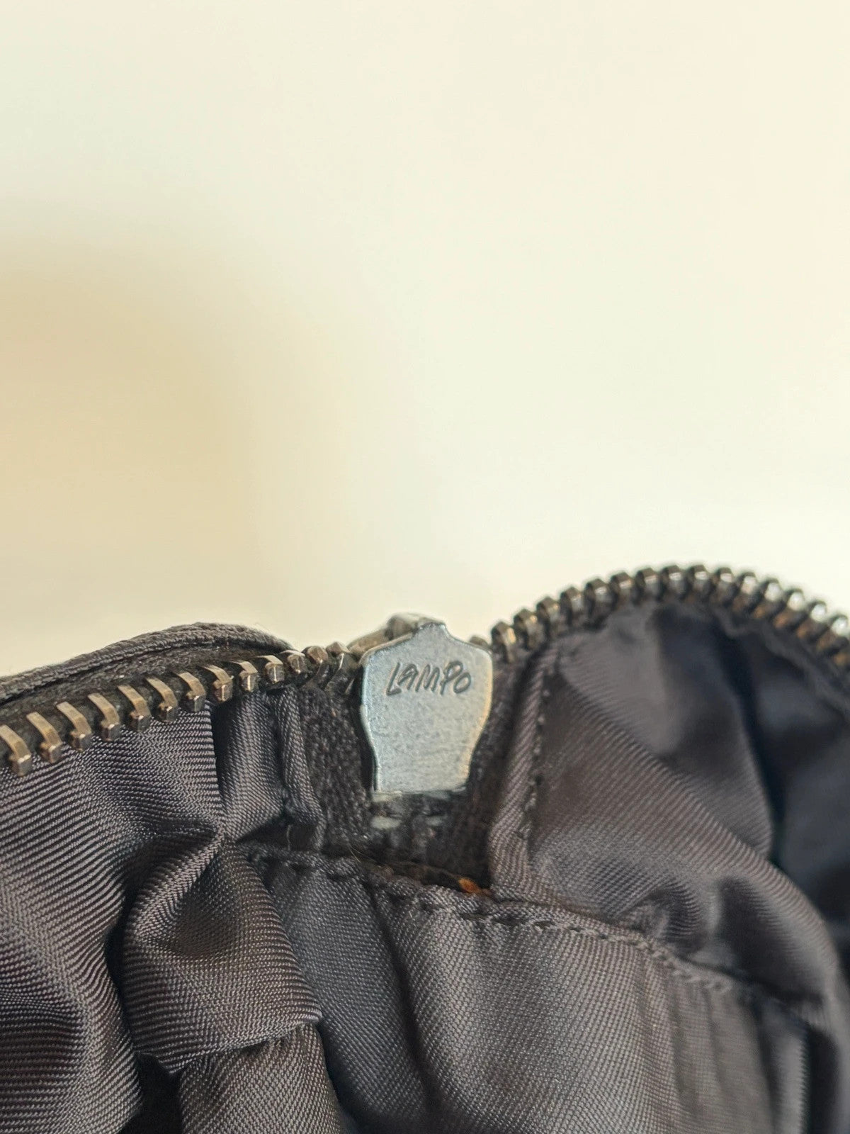 Chanel black handbag woven nylon jacquard with repeating CC monogram and leather trim.