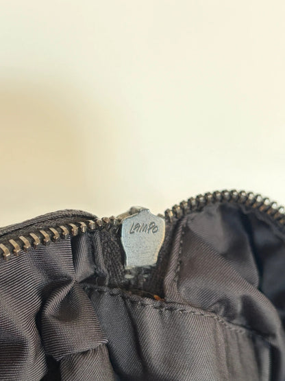 Chanel black handbag woven nylon jacquard with repeating CC monogram and leather trim.