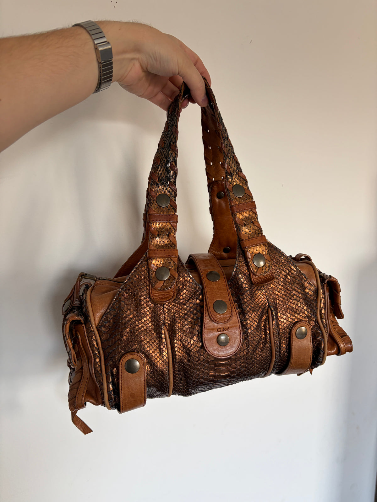 Chloé Silverado bag in metallic bronze python with whipstitched handles and studs