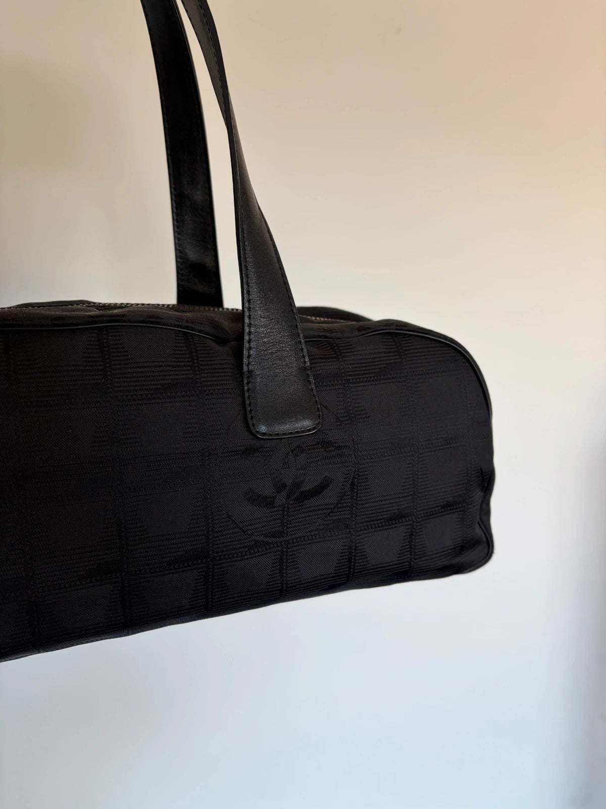 Chanel black handbag woven nylon jacquard with repeating CC monogram and leather trim.