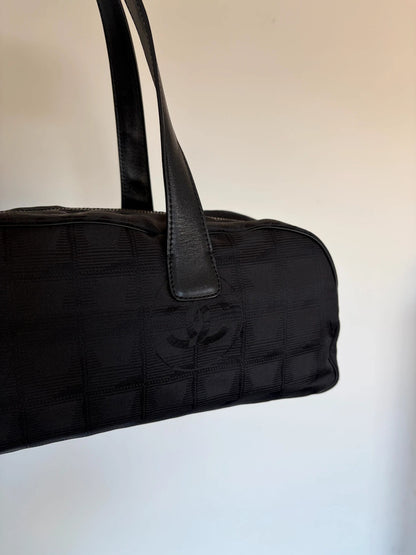 Chanel black handbag woven nylon jacquard with repeating CC monogram and leather trim.