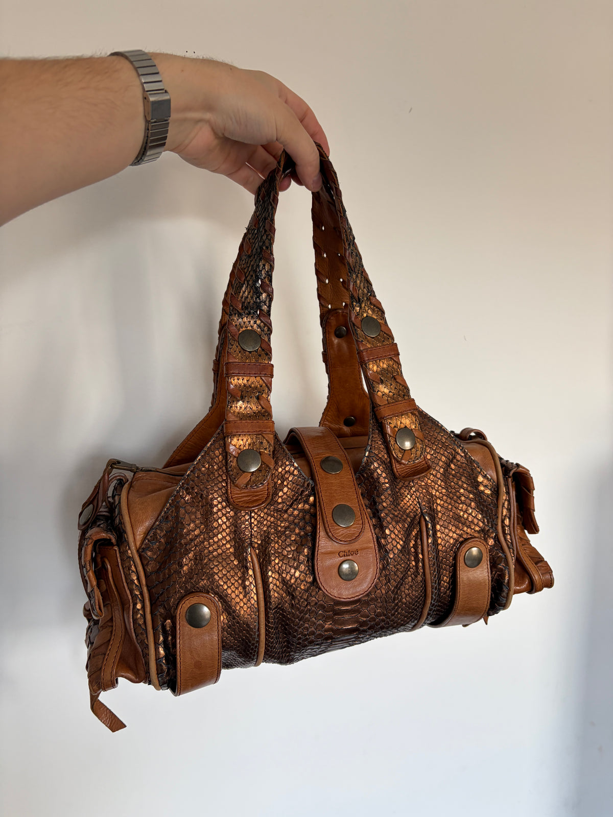Chloé Silverado bag in metallic bronze python with whipstitched handles and studs