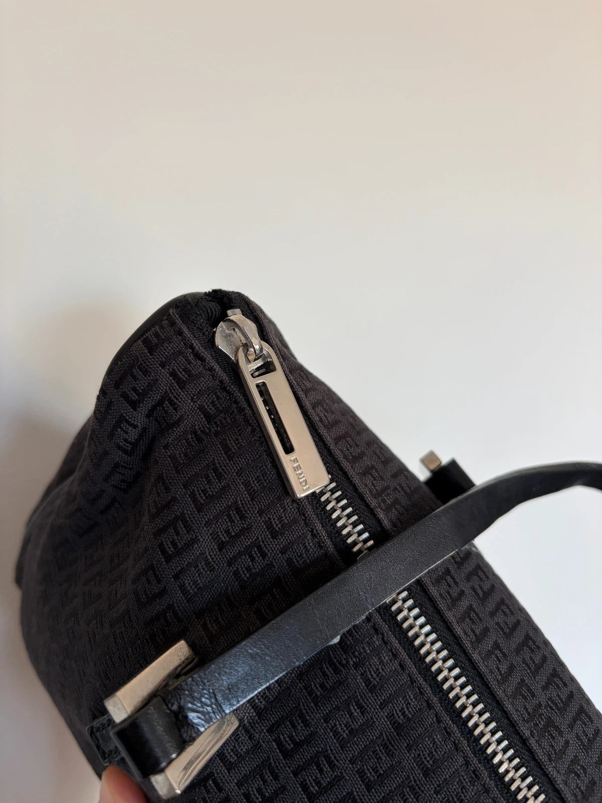 Fendi black shoulder bag with Zucchino monogram canvas, silver-tone hardware, and leather trim.