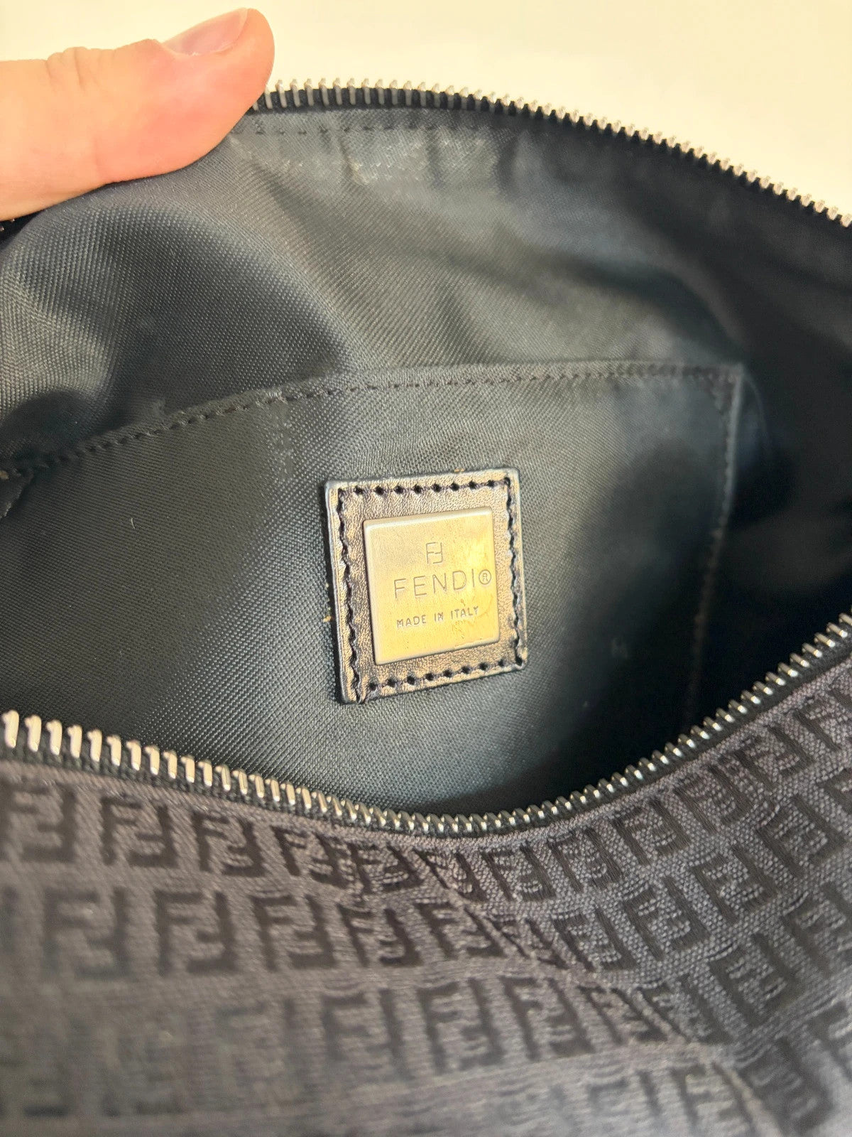 Fendi black shoulder bag with Zucchino monogram canvas, silver-tone hardware, and leather trim.