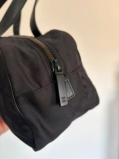 Chanel black handbag woven nylon jacquard with repeating CC monogram and leather trim.