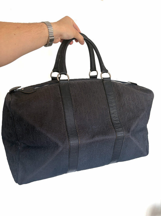 Christian Dior black duffel bag embossed jacquard fabric with leather trim and handles.