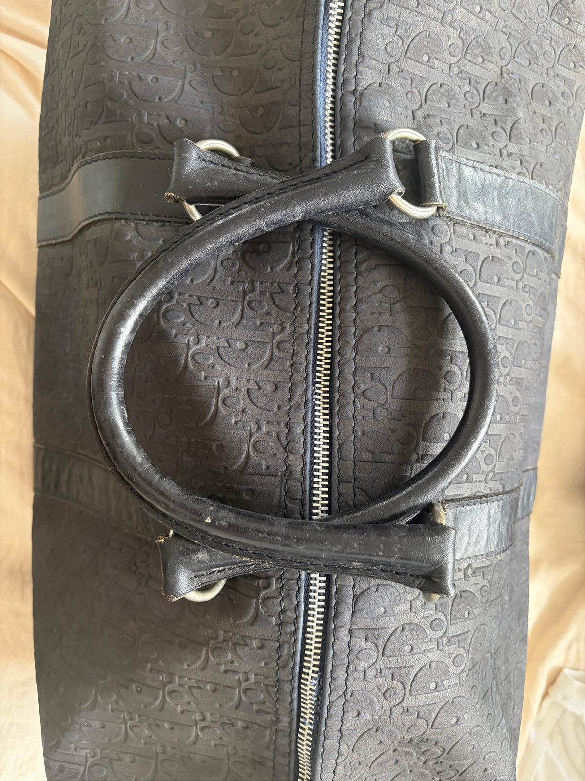 Christian Dior black duffel bag embossed jacquard fabric with leather trim and handles.