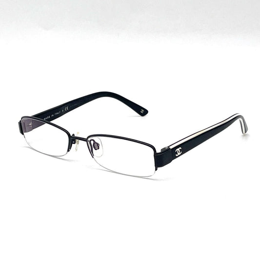 Chanel black rectangular rimless eyeglasses with white CC detailing and adjustable nose pads.