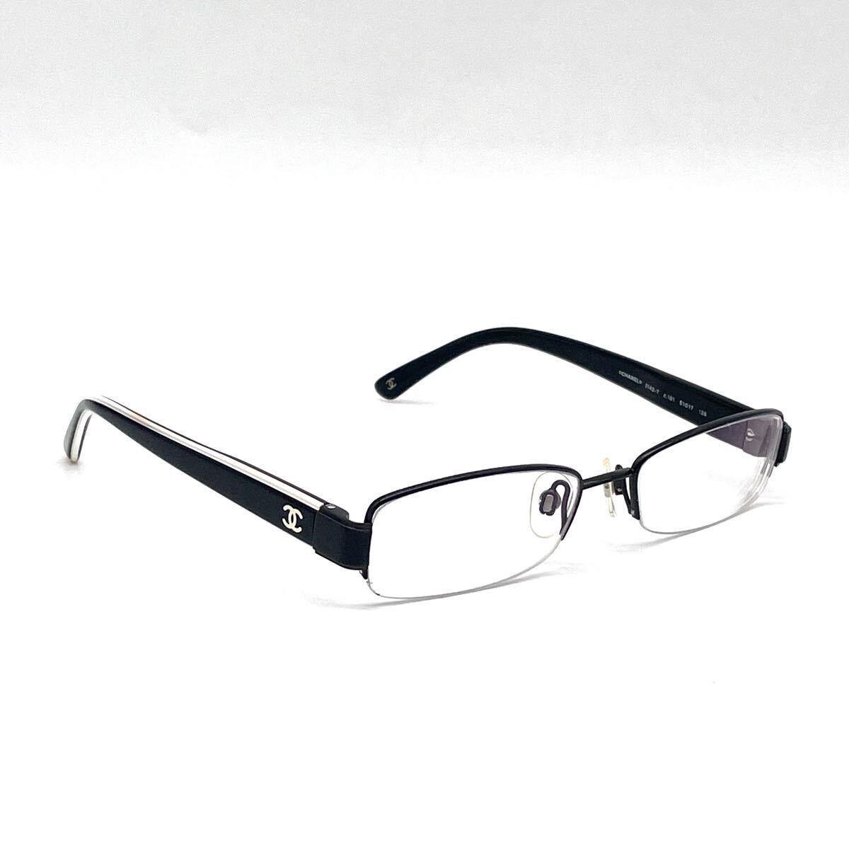 Chanel black rectangular rimless eyeglasses with white CC detailing and adjustable nose pads.