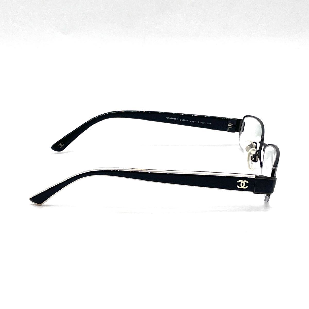 Chanel black rectangular rimless eyeglasses with white CC detailing and adjustable nose pads.