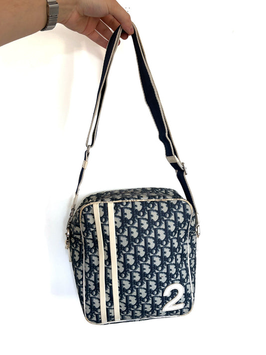 Christian Dior beige and navy crossbody bag with Trotter monogram and leather trim.